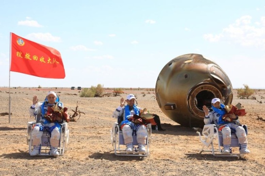 90 nap után az űrből visszatérő kínai űrhajósok. Pár napig feküdniük kell, mire szervezetük alkalmazkodik a földi gravitációhoz.